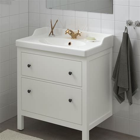Kara Whitten refaced this formerly black unit by adding new natural wood fronts and small dowels, held together with Liquid Nails glue. . Ikea bathroom sinks